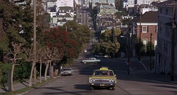 Movie still from “Guess Who's Coming to Dinner” (1967), directed by Stanley Kramer – A taxi cab driving down a street past tall buildings; Extreme Wide shot, High angle