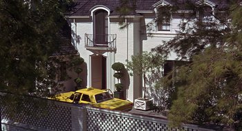 Movie still from “Guess Who's Coming to Dinner” (1967), directed by Stanley Kramer – A yellow car parked in front of a white house; Extreme Wide shot, Low angle