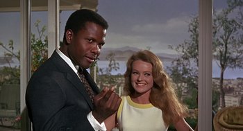 Movie still from “Guess Who's Coming to Dinner” (1967), directed by Stanley Kramer – A man and a woman standing next to each other; Medium shot, Low angle