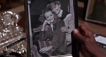 Movie still from “Guess Who's Coming to Dinner” (1967), directed by Stanley Kramer – An old photo of a woman and a girl; Close Up shot, High angle