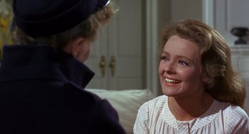 Movie still from “Guess Who's Coming to Dinner” (1967), directed by Stanley Kramer – A woman smiles as she talks to another woman; Close Up shot, Over the shoulder angle