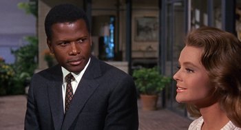 Movie still from “Guess Who's Coming to Dinner” (1967), directed by Stanley Kramer – A man in a business suit and a woman in a business suit; Close Up shot, Over the shoulder angle