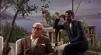 Movie still from “Guess Who's Coming to Dinner” (1967), directed by Stanley Kramer – Two men in suits sitting next to each other; Medium shot, Over the shoulder angle