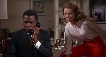 Movie still from “Guess Who's Coming to Dinner” (1967), directed by Stanley Kramer – A man and a woman on the phone in a room; Medium shot, Low angle
