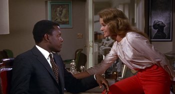 Movie still from “Guess Who's Coming to Dinner” (1967), directed by Stanley Kramer – A man and a woman are holding hands in a living room; Medium shot, Low angle