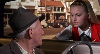 Movie still from “Guess Who's Coming to Dinner” (1967), directed by Stanley Kramer – An older man and a young woman sitting in the back of a car; Medium shot, Over the shoulder angle