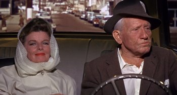Movie still from “Guess Who's Coming to Dinner” (1967), directed by Stanley Kramer – An older man and woman sitting next to each other in a car; Medium shot, Low angle