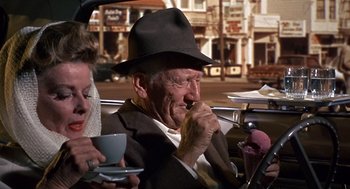 Movie still from “Guess Who's Coming to Dinner” (1967), directed by Stanley Kramer – An old man in a hat and a woman in a car; Medium shot, High angle