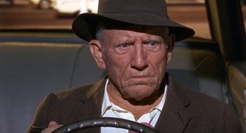 Movie still from “Guess Who's Coming to Dinner” (1967), directed by Stanley Kramer – An older man wearing a hat and driving a car; Close Up shot, Over the shoulder angle