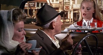 Movie still from “Guess Who's Coming to Dinner” (1967), directed by Stanley Kramer – An older man sitting in the drivers seat of a car; Medium shot, Over the shoulder angle