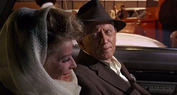Movie still from “Guess Who's Coming to Dinner” (1967), directed by Stanley Kramer – An older man and woman sitting next to each other in a car; Close Up shot, Over the shoulder angle