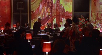Movie still from “Guess Who's Coming to Dinner” (1967), directed by Stanley Kramer – A group of people sitting at a table in a restaurant; Wide shot, Low angle