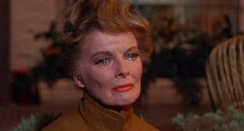 Movie still from “Guess Who's Coming to Dinner” (1967), directed by Stanley Kramer – An older woman wearing a brown jacket and a red lipstick; Close Up shot, Over the shoulder angle