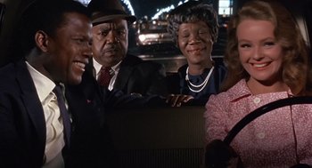 Movie still from “Guess Who's Coming to Dinner” (1967), directed by Stanley Kramer – A group of people standing around each other in a room; Medium shot, Over the shoulder angle