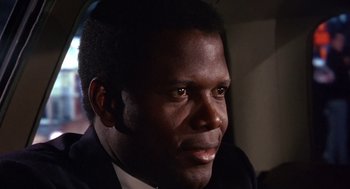 Movie still from “Guess Who's Coming to Dinner” (1967), directed by Stanley Kramer – A person wearing a suit and tie; Close Up shot, Low angle
