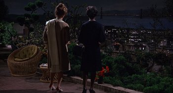 Movie still from “Guess Who's Coming to Dinner” (1967), directed by Stanley Kramer – Two women are standing on a patio overlooking a city at night; Wide shot, High angle