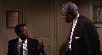 Movie still from “Guess Who's Coming to Dinner” (1967), directed by Stanley Kramer – Two men in business suits talking to each other; Medium shot, Over the shoulder angle