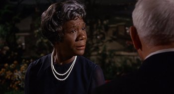 Movie still from “Guess Who's Coming to Dinner” (1967), directed by Stanley Kramer – An older black woman wearing a pearl necklace; Close Up shot, Over the shoulder angle