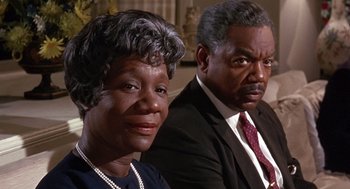 Movie still from “Guess Who's Coming to Dinner” (1967), directed by Stanley Kramer – A man and a woman sitting next to each other; Close Up shot, High angle