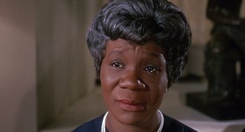 Movie still from “Guess Who's Coming to Dinner” (1967), directed by Stanley Kramer – An older black woman wearing a pearl necklace; Close Up shot, Low angle