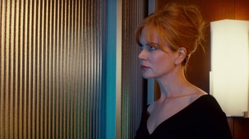 Movie still from “Trespass” (2011), directed by Joel Schumacher – A woman with red hair looking to her left; Close Up shot, Over the shoulder angle