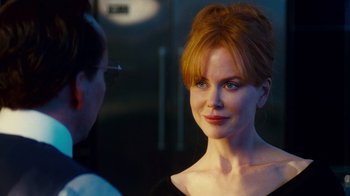 Movie still from “Trespass” (2011), directed by Joel Schumacher – A beautiful woman with red hair standing next to a man; Close Up shot, Over the shoulder angle