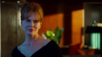 Movie still from “Trespass” (2011), directed by Joel Schumacher – A person wearing a black dress; Close Up shot, Over the shoulder angle