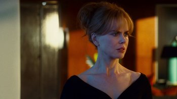 Movie still from “Trespass” (2011), directed by Joel Schumacher – A woman in a black dress looking to her left; Close Up shot, Over the shoulder angle