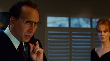 Movie still from “Trespass” (2011), directed by Joel Schumacher – A man in a suit and tie talking on a cell phone; Close Up shot, Over the shoulder angle