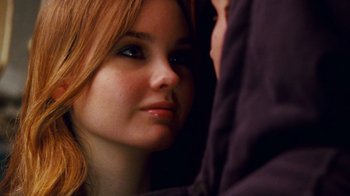 Movie still from “Trespass” (2011), directed by Joel Schumacher – A person with long red hair; Close Up shot, Over the shoulder angle