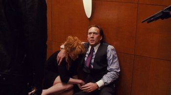 Movie still from “Trespass” (2011), directed by Joel Schumacher – A man and a woman sitting next to each other on the floor; Medium shot, Low angle
