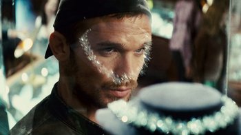 Movie still from “Trespass” (2011), directed by Joel Schumacher – A person with a face paint on; Close Up shot, Over the shoulder angle