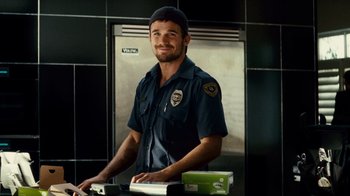 Movie still from “Trespass” (2011), directed by Joel Schumacher – A man in a police uniform standing in front of an oven; Medium shot, Low angle