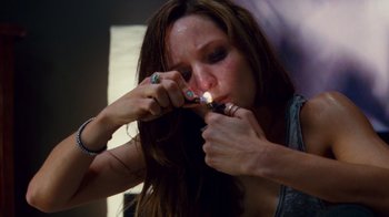 Movie still from “Trespass” (2011), directed by Joel Schumacher – A woman is holding a tooth brush in her mouth; Close Up shot, High angle