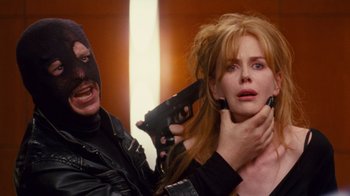 Movie still from “Trespass” (2011), directed by Joel Schumacher – A man and a woman holding guns in a room; Close Up shot, Over the shoulder angle