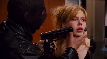 Movie still from “Trespass” (2011), directed by Joel Schumacher – A man holding a gun pointed at a woman's face; Close Up shot, Over the shoulder angle