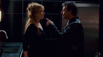 Movie still from “Trespass” (2011), directed by Joel Schumacher – A man and a woman in a black room; Close Up shot, Over the shoulder angle