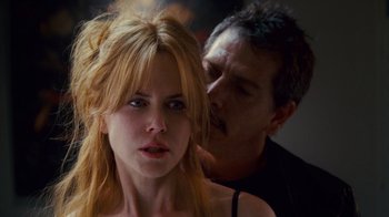 Movie still from “Trespass” (2011), directed by Joel Schumacher – A man kissing a woman on the side of her face; Close Up shot, Over the shoulder angle