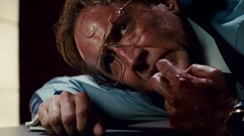 Movie still from “Trespass” (2011), directed by Joel Schumacher – A person with a knife in his mouth; Close Up shot, Low angle