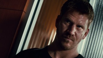 Movie still from “Trespass” (2011), directed by Joel Schumacher – A person wearing a black t - shirt; Close Up shot, Low angle
