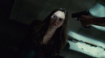 Movie still from “Trespass” (2011), directed by Joel Schumacher – A woman with long brown hair is holding a hair dryer; Close Up shot, Over the shoulder angle