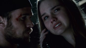 Movie still from “Trespass” (2011), directed by Joel Schumacher – A man and a woman looking at each other while talking on a phone; Close Up shot, Over the shoulder angle