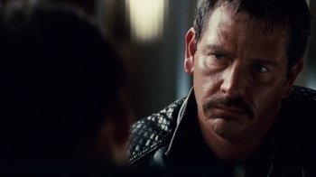 Movie still from “Trespass” (2011), directed by Joel Schumacher – A person wearing a leather jacket; Close Up shot, Over the shoulder angle