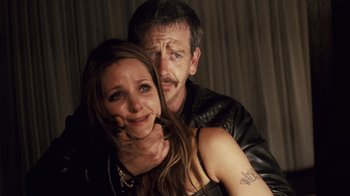 Movie still from “Trespass” (2011), directed by Joel Schumacher – A man and a woman posing for a picture; Close Up shot, Over the shoulder angle