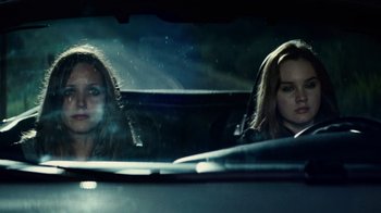 Movie still from “Trespass” (2011), directed by Joel Schumacher – Two women in the back seat of a car looking out of the window; Close Up shot, Over the shoulder angle