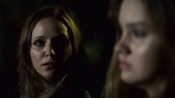 Movie still from “Trespass” (2011), directed by Joel Schumacher – A woman is looking at the camera while another woman is looking at the camera; Close Up shot, Over the shoulder angle