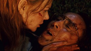Movie still from “Trespass” (2011), directed by Joel Schumacher – A man and a woman face to face with blood on their face; Close Up shot, Low angle