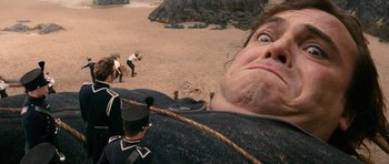 Movie still from “Gulliver's Travels” (2010), directed by Rob Letterman – An image of a man in a uniform looking up at the sky; Extreme Close Up shot, Overhead angle