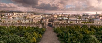Movie still from “Gulliver's Travels” (2010), directed by Rob Letterman – An aerial view of a city with a cloudy sky above it; Extreme Wide shot, High angle