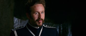 Movie still from “Gulliver's Travels” (2010), directed by Rob Letterman – A person with a beard wearing a uniform; Close Up shot, Over the shoulder angle